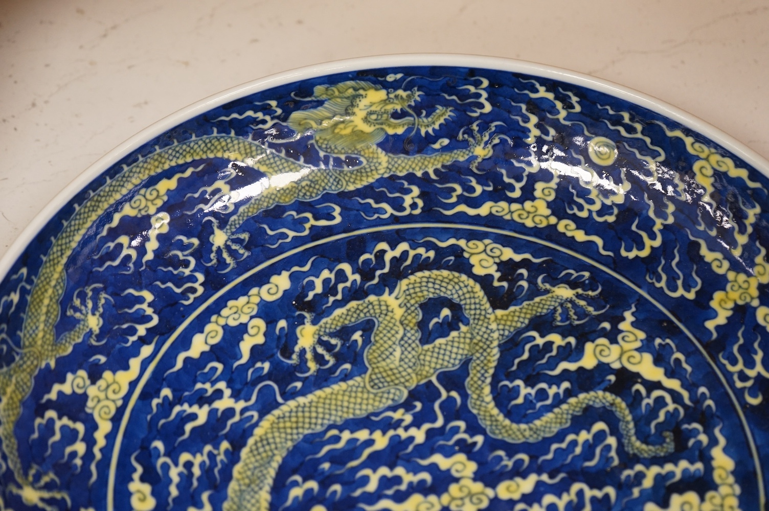 A Chinese blue and yellow glazed dragon dish, 33cm diameter., Condition - good